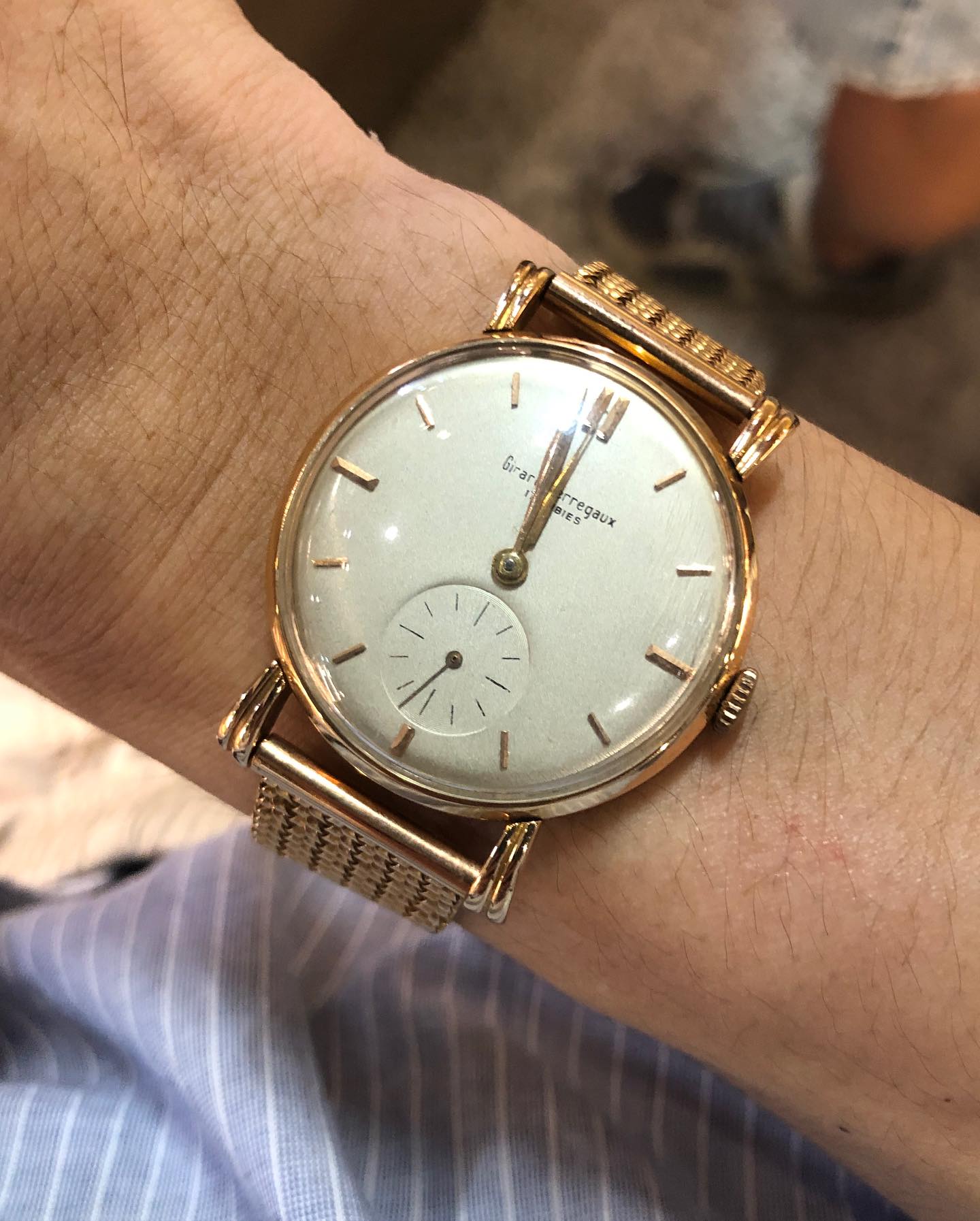 Girard-Perregaux with small seconds and a woven bracelet, worn on the wrist